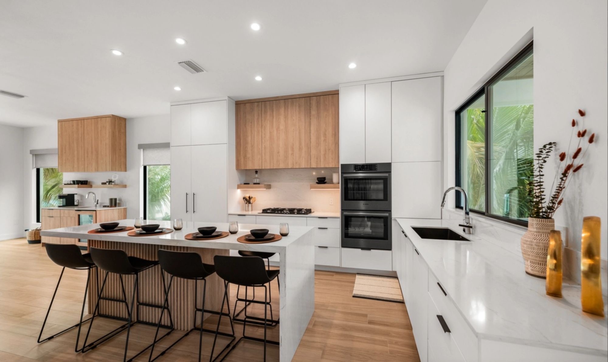 A custom white and oak kitchen built by Sarasota Cabinets and Design