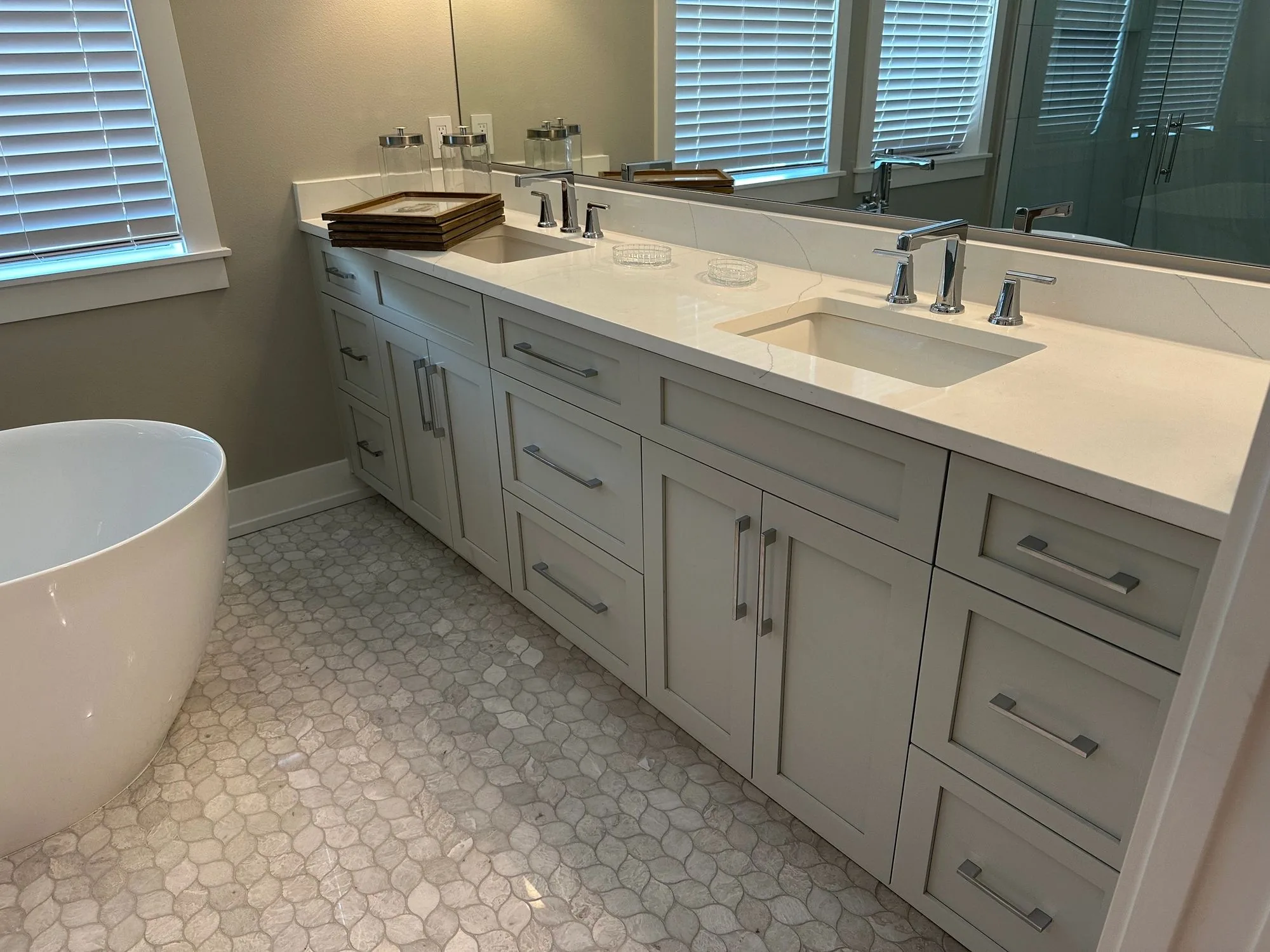 A shaker double vanity in a bath with a freestanding tub